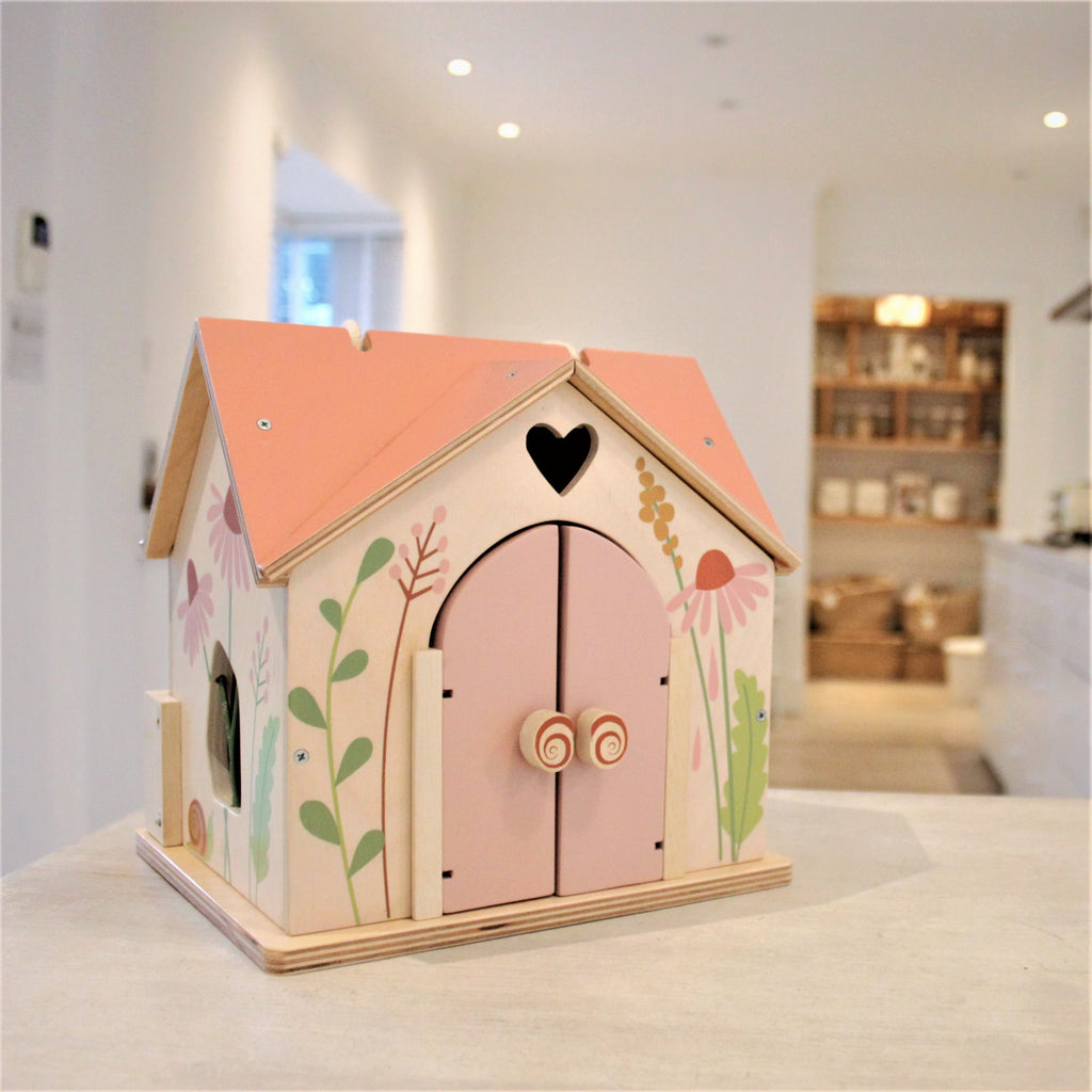 tenderleaf toys plastic free dolls house wood set with doll family and lots of doll house furniture all finished with colour safe paints. Sustainable toys gift ideas for children